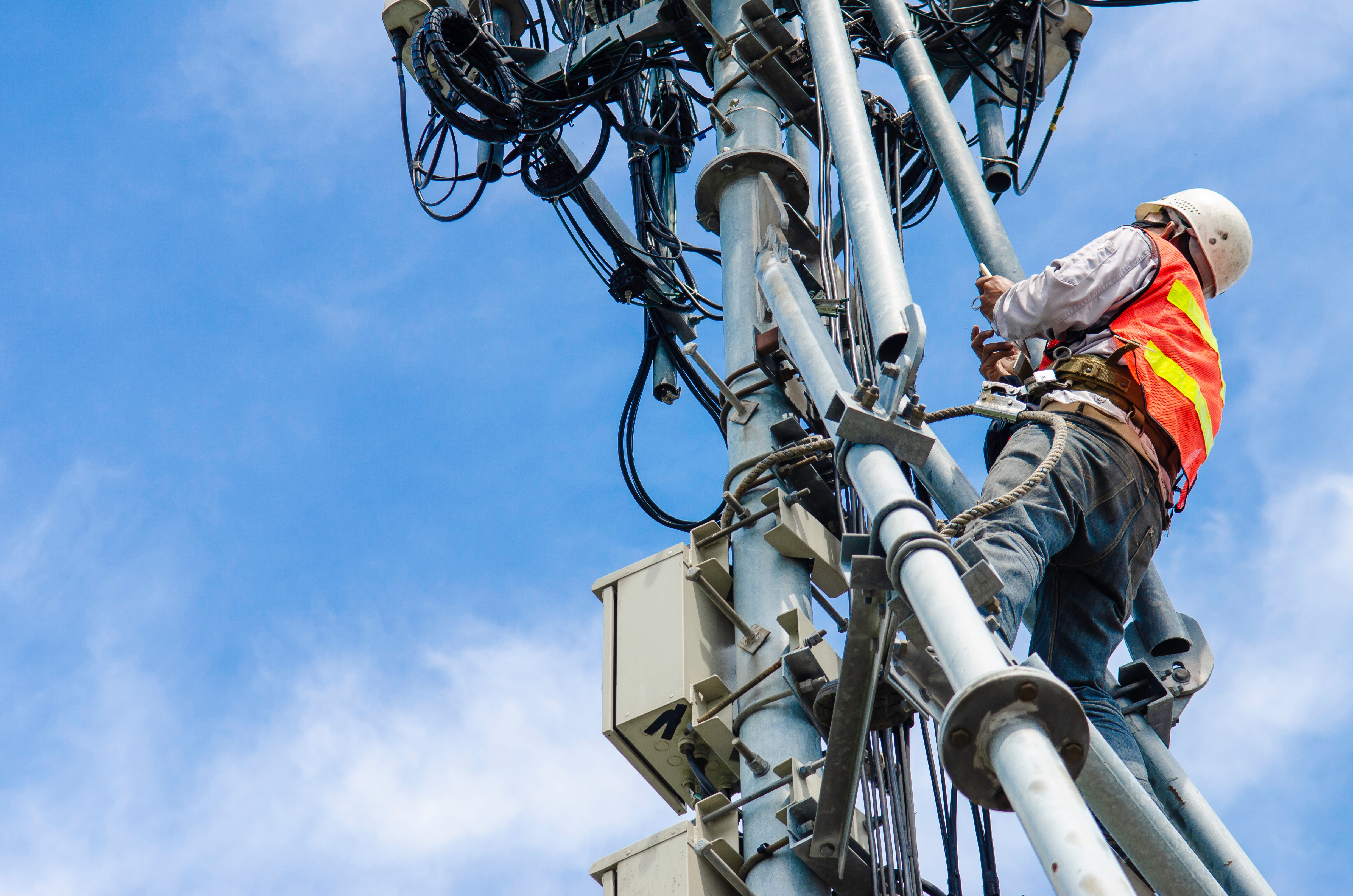 technician working on high telecommunication tower,worker wear P